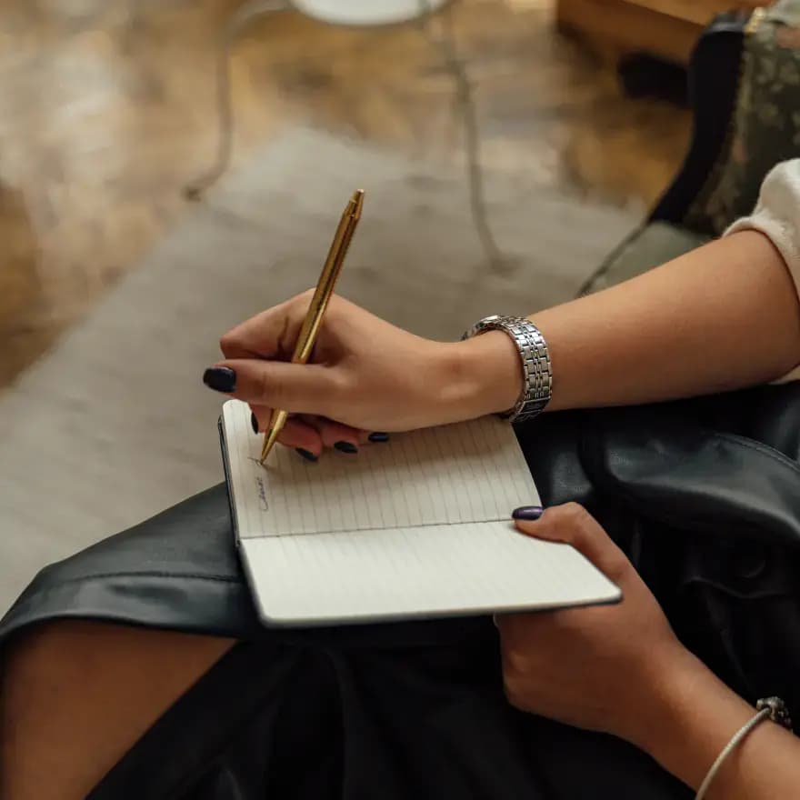 Image of person writing in journal