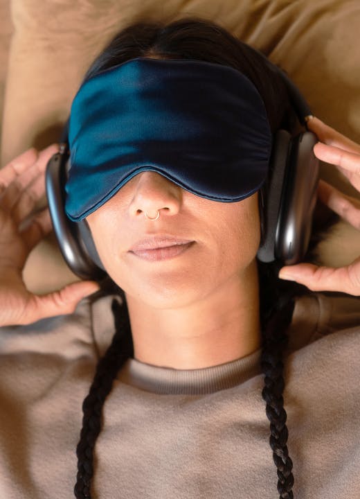 Woman with face mask and headphones